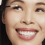 Asian woman with hooded eyelids wearing reuseable false eyelashes