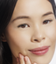 Asian woman with hooded eyelids wearing reuseable false eyelashes