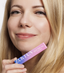 Woman with monolid eyes applying at-home DIY eyelash extensions