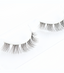 Beautiful woman applying her own lash extensions at home