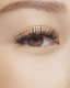 Asian woman applying natural looking fake lashes 