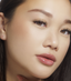 Woman with hooded eyes applying lash adhesive that is made in Korea