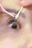 Woman with monolid eyes applying at-home DIY eyelash extensions