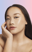 Woman with monolid eyes applying at-home DIY eyelash extensions
