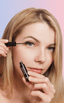 Woman with monolid eyes applying at-home DIY eyelash extensions