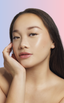 Woman with monolid eyes applying at-home DIY eyelash extensions