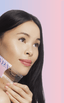 Woman with monolid eyes applying at-home DIY eyelash extensions