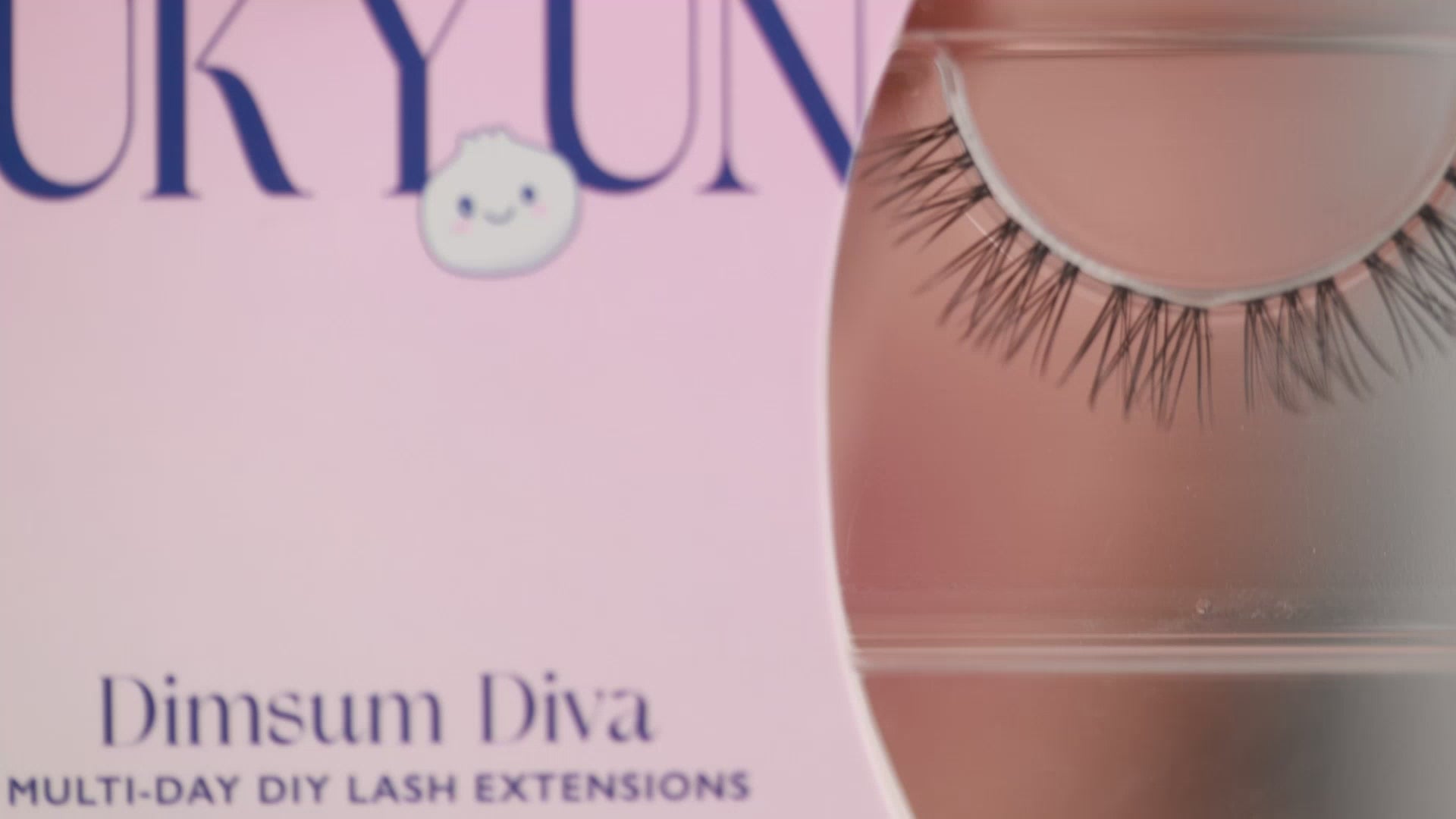 Woman with monolid eyes applying at-home DIY eyelash extensions