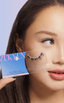 Woman with monolid eyes applying at-home DIY eyelash extensions